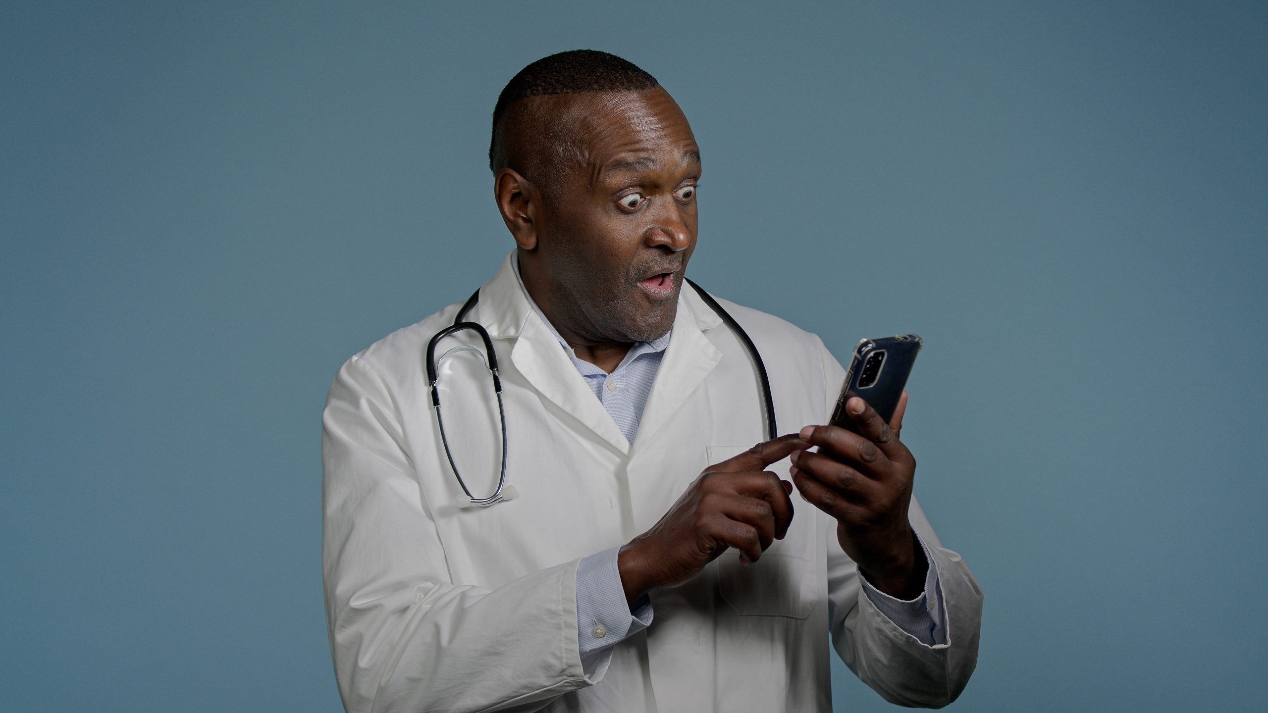Doctor receiving a message on his mobile phone