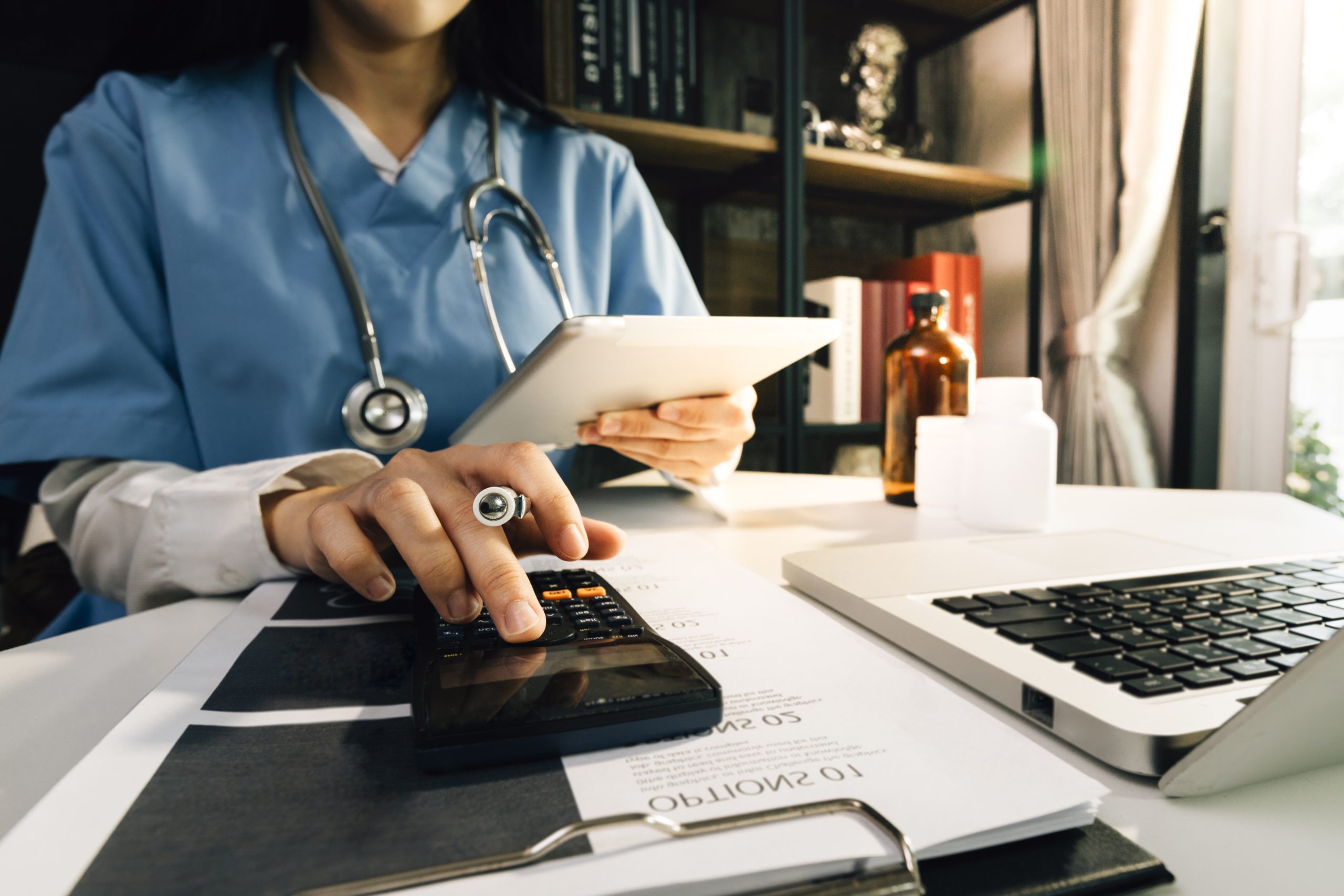 Doctor using a tablet to review medical and business information
