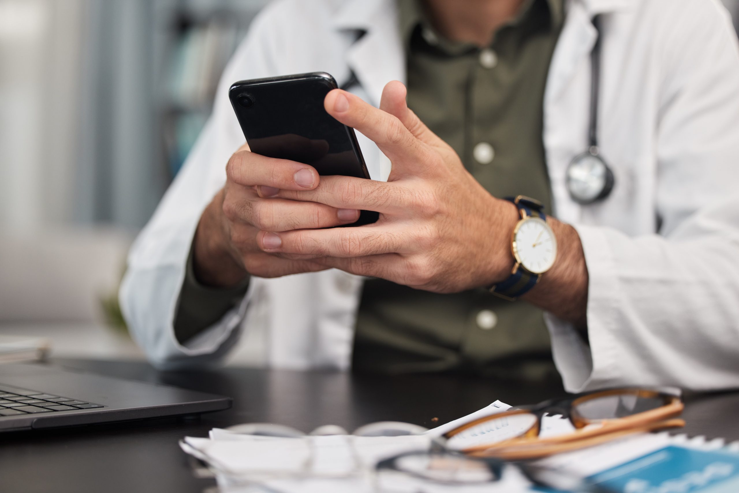 Doctor using a mobile phone in a medical office